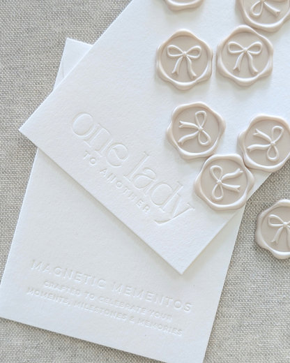 Close-up of debossed branded stationery and wax seal swatches