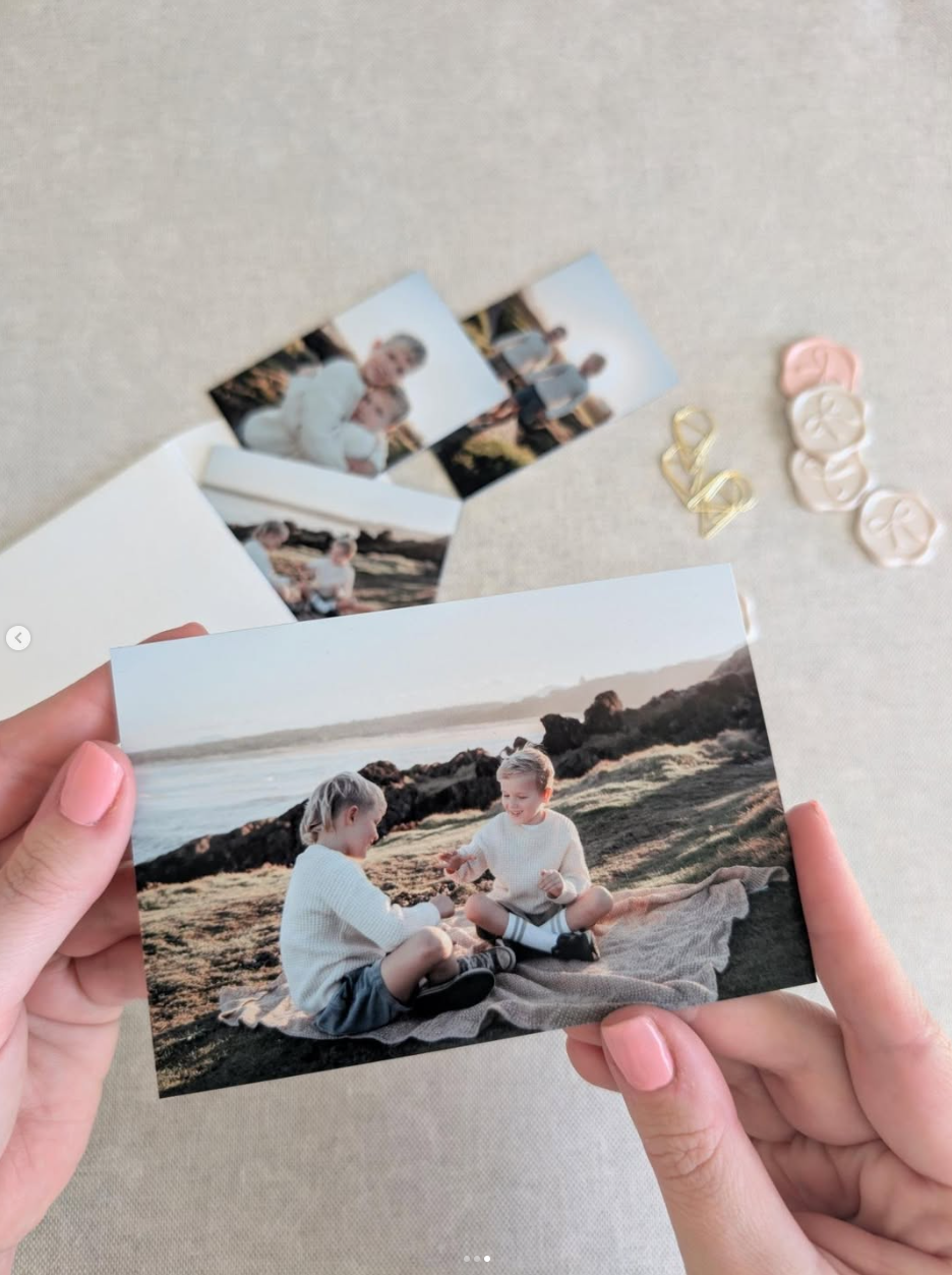 Photographer holding a magnetic photo print with other samples and wax seal swatches